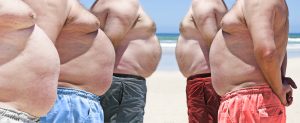 Five very obese fat men on the beach