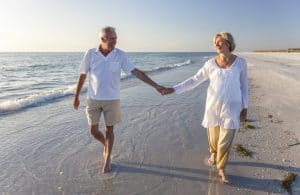 Elderly Couple Walking on Beach