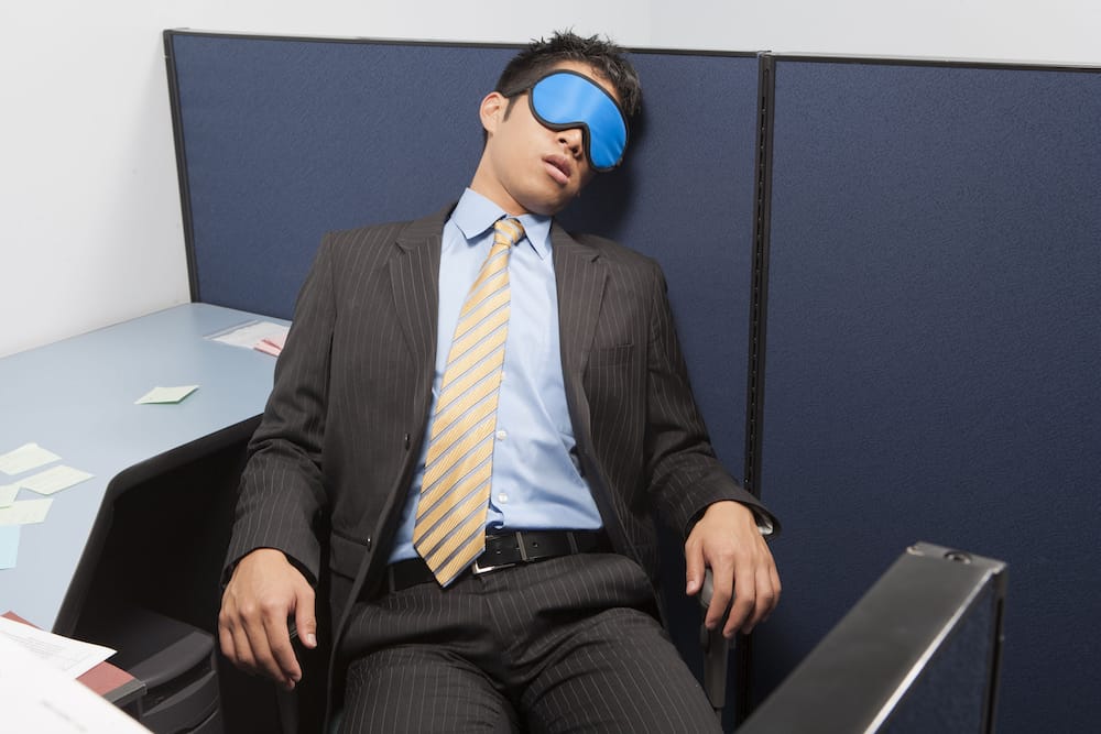 Businessperson sleeping in office